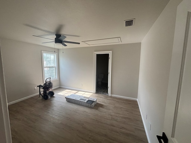 909 E Moore St, Valdosta, GA 31601 - unfurnished room featuring attic access, wood finished floors, a ceiling fan, and baseboards