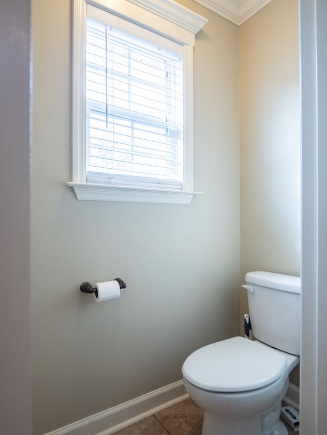 bathroom featuring ornamental molding, tile patterned floors, and toilet