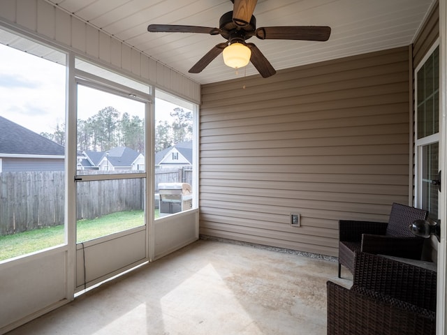 unfurnished sunroom with plenty of natural light and ceiling fan