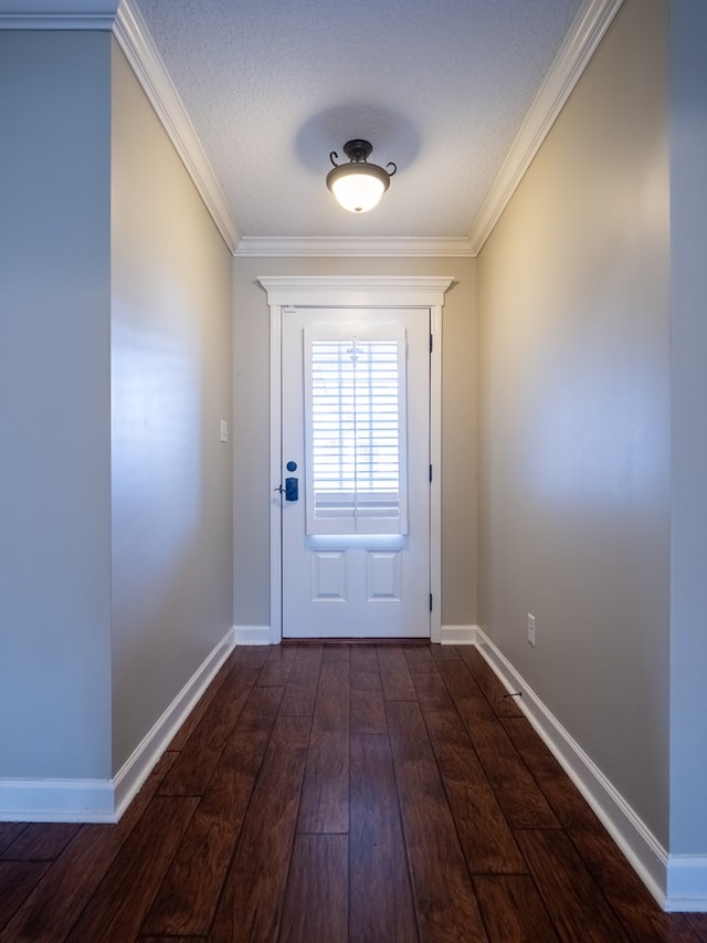 doorway to outside with dark wood-type flooring, ornamental molding, and a textured ceiling