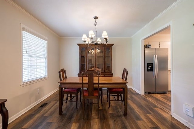 dining room with a notable chandelier, dark hardwood / wood-style flooring, and crown molding