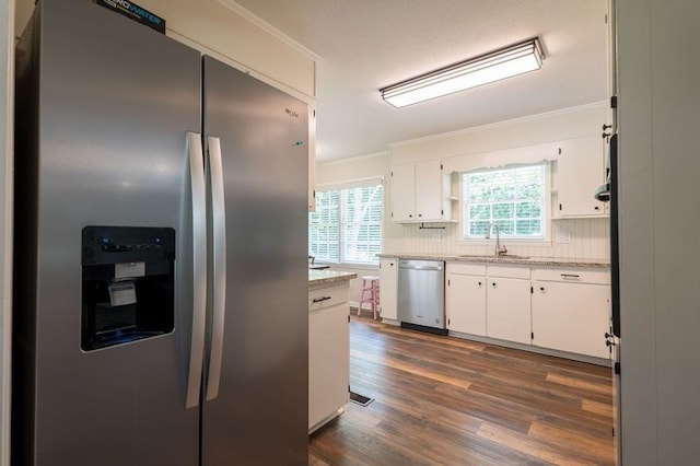 kitchen with backsplash, sink, white cabinetry, stainless steel appliances, and dark hardwood / wood-style flooring