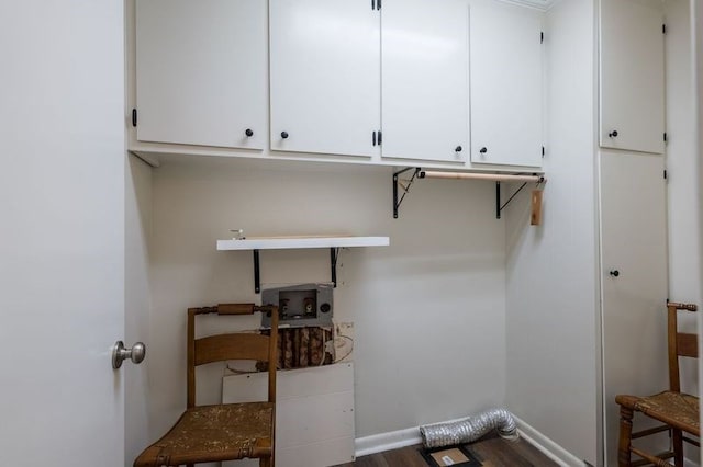 washroom featuring hardwood / wood-style flooring and cabinets