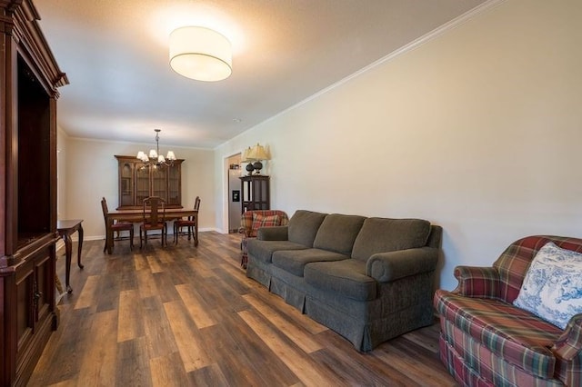 living room with crown molding, dark hardwood / wood-style floors, and a notable chandelier