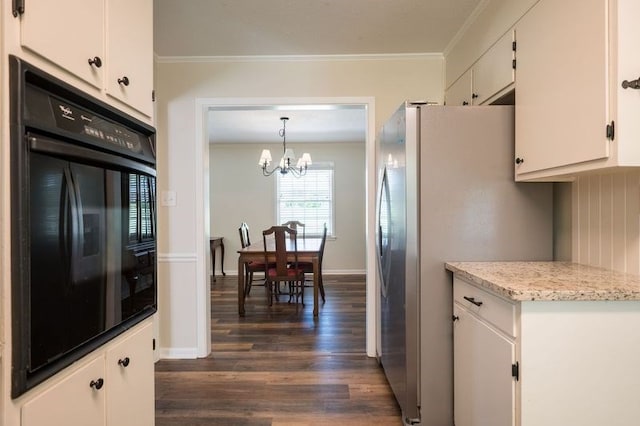 kitchen with pendant lighting, white cabinetry, an inviting chandelier, oven, and stainless steel refrigerator