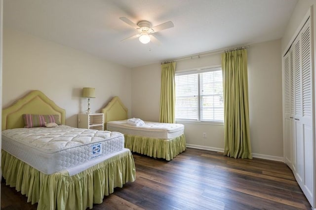 bedroom with a closet, dark hardwood / wood-style flooring, and ceiling fan