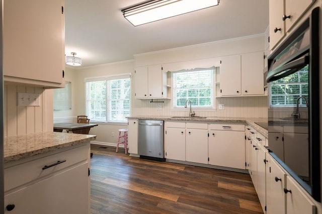 kitchen featuring stainless steel dishwasher, white cabinets, light stone countertops, and sink