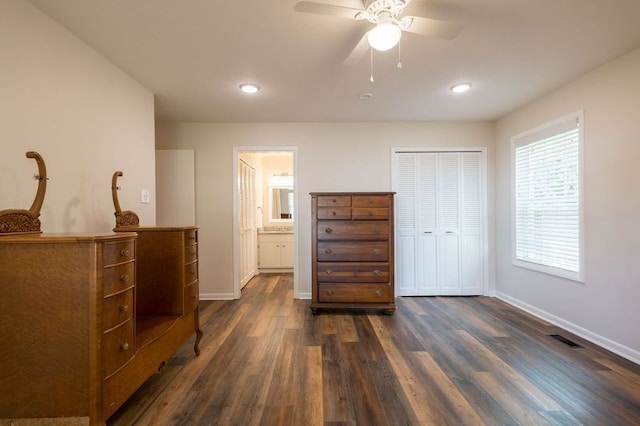 bedroom featuring a closet, ensuite bathroom, dark hardwood / wood-style floors, and ceiling fan