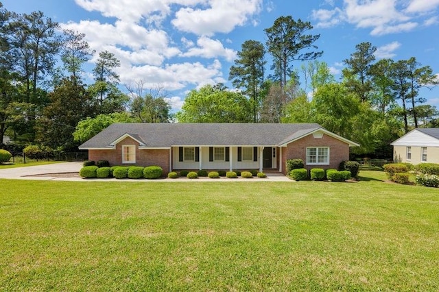 single story home with covered porch and a front yard