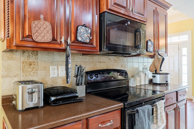 kitchen with ornamental molding, backsplash, black appliances, and dark brown cabinets