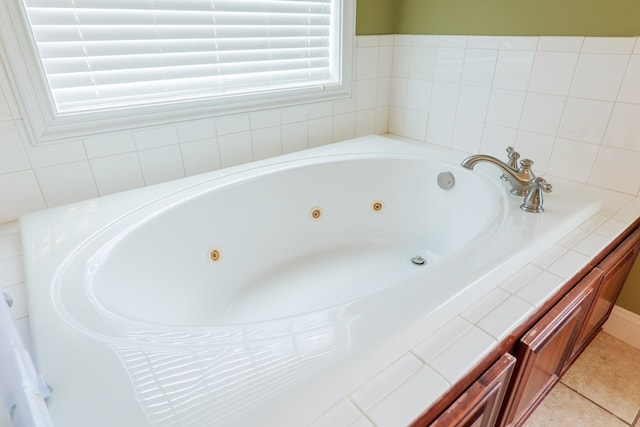 bathroom with a jetted tub and tile patterned floors