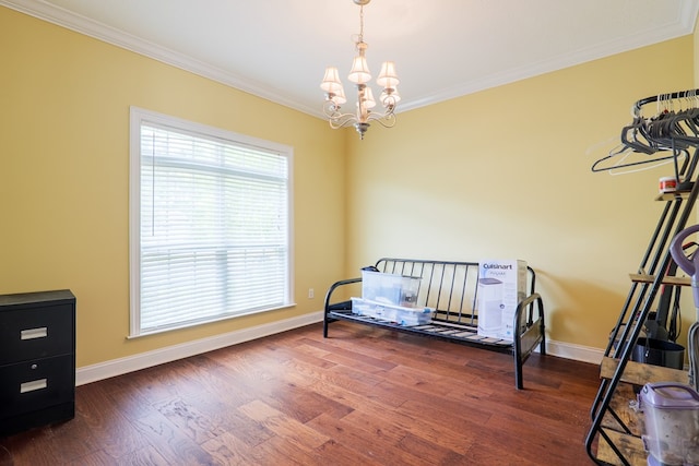 bedroom with baseboards, ornamental molding, a chandelier, and wood finished floors