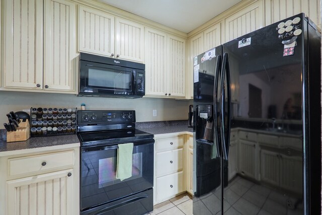 5187 Branch Point Dr, Valdosta, GA 31605 - kitchen featuring black appliances, cream cabinets, light tile patterned floors, and dark countertops
