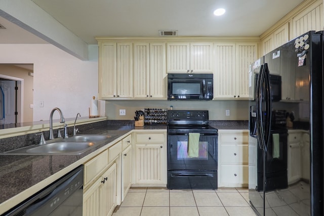 5187 Branch Point Dr, Valdosta, GA 31605 - kitchen featuring black appliances, cream cabinetry, light tile patterned floors, and dark countertops
