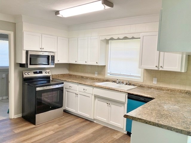 619 Lakeview Dr, Adel, GA 31620 - kitchen featuring appliances with stainless steel finishes, a sink, white cabinets, and light wood-style floors