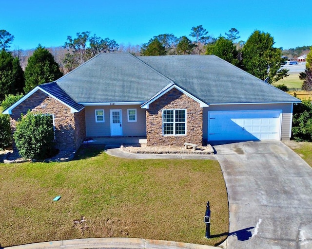 ranch-style house with a garage and a front lawn