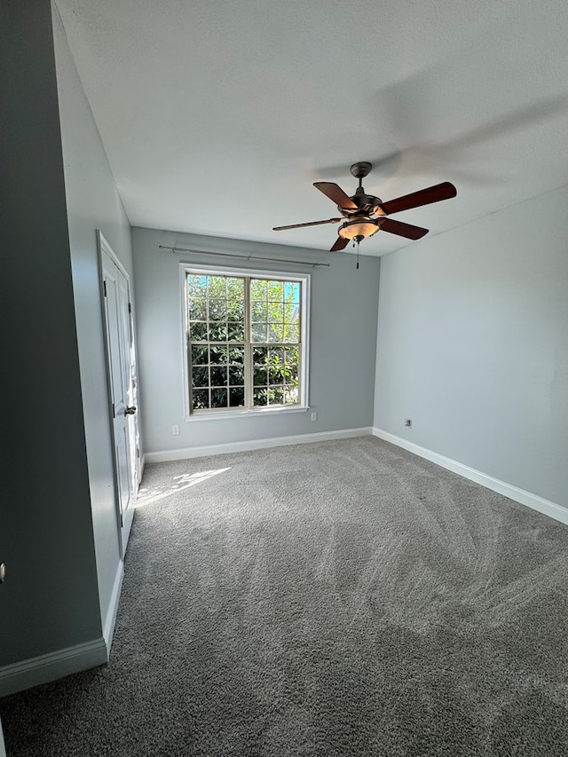 unfurnished room with carpet flooring and ceiling fan