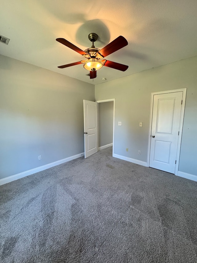 unfurnished bedroom featuring ceiling fan and carpet