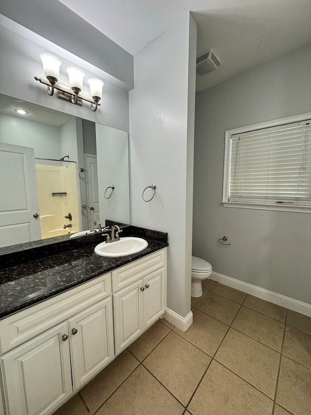 bathroom featuring walk in shower, tile patterned flooring, vanity, and toilet