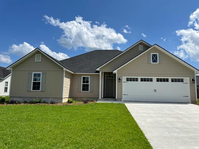 view of front facade featuring a garage and a front lawn