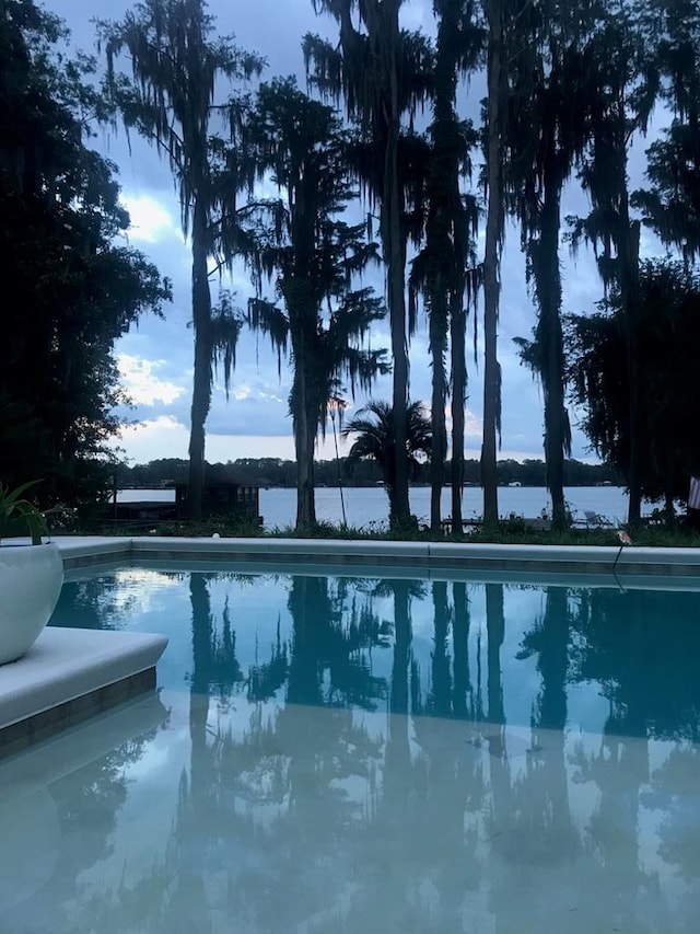 view of pool featuring a water view