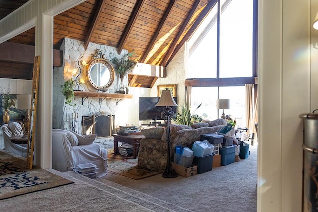 carpeted living room with beamed ceiling, high vaulted ceiling, a fireplace, and wood ceiling