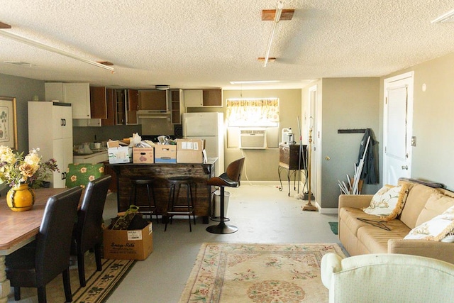 interior space with cooling unit and a textured ceiling