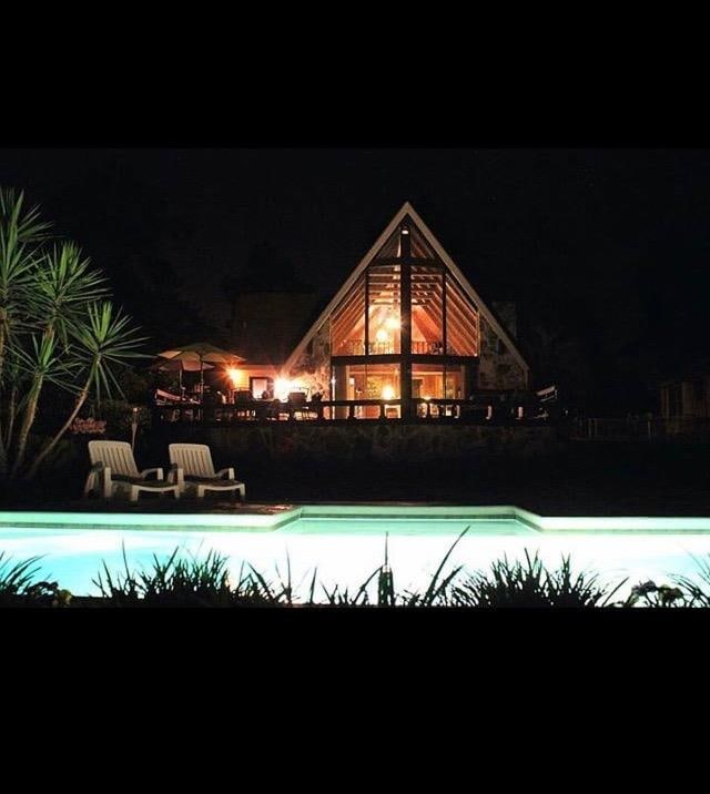 view of pool at twilight