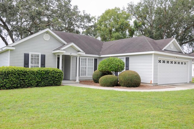 single story home with a garage and a front lawn