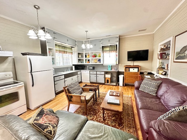 living room with sink, light hardwood / wood-style flooring, crown molding, and an inviting chandelier