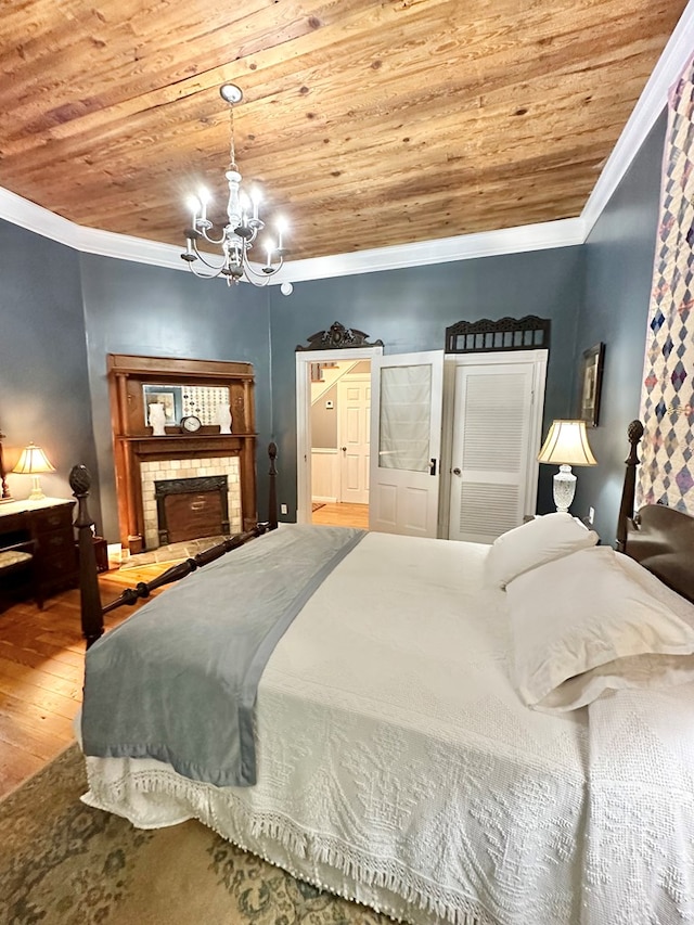 bedroom with wood-type flooring, wood ceiling, crown molding, and a notable chandelier