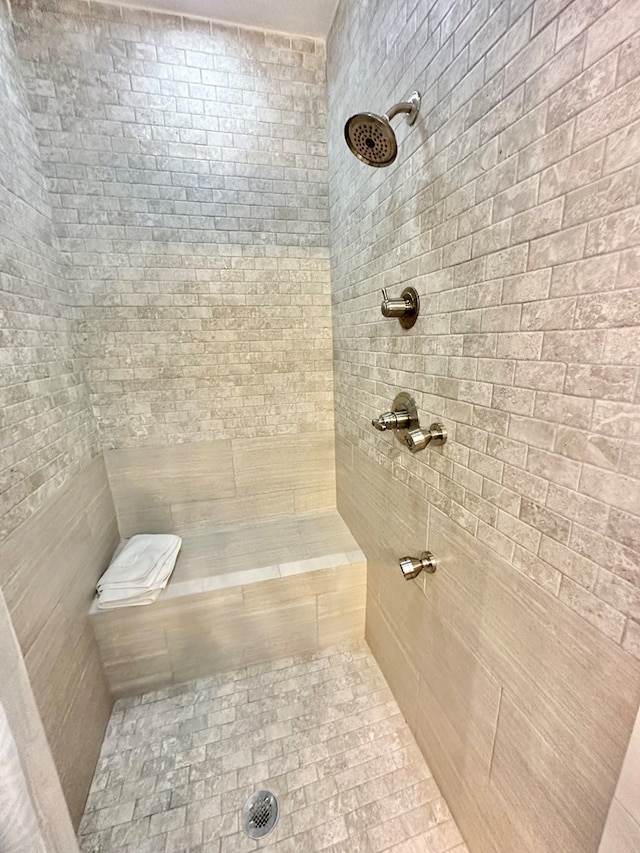 bathroom with tiled shower