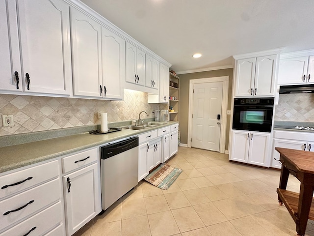 kitchen with backsplash, light tile patterned flooring, black appliances, white cabinets, and sink