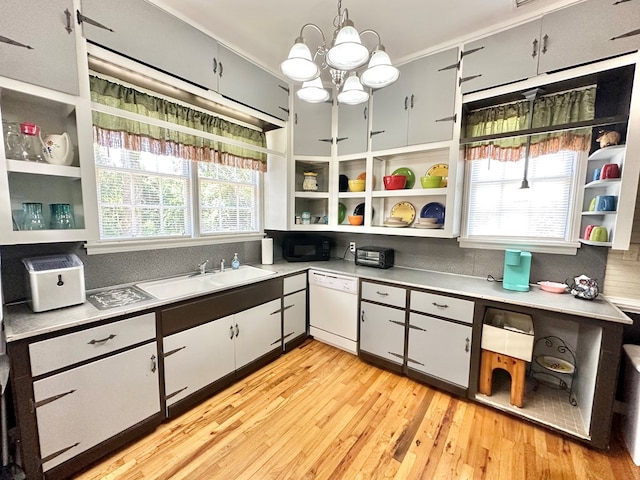 kitchen with an inviting chandelier, white cabinetry, light wood-type flooring, dishwasher, and pendant lighting