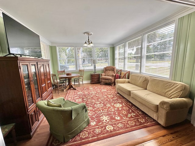 sunroom featuring a healthy amount of sunlight and an inviting chandelier