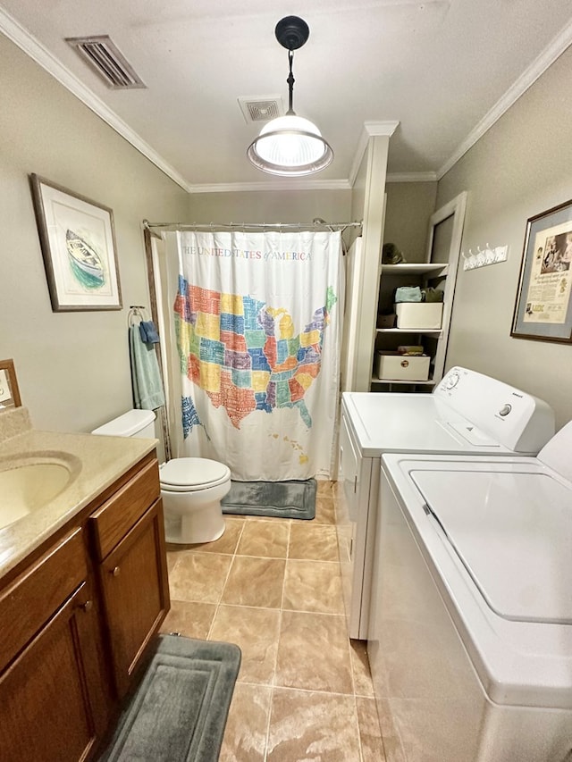 bathroom with washing machine and dryer, crown molding, tile patterned floors, and vanity