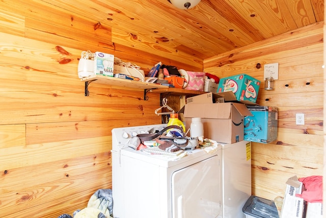 laundry room featuring washer and clothes dryer, wooden ceiling, and wooden walls