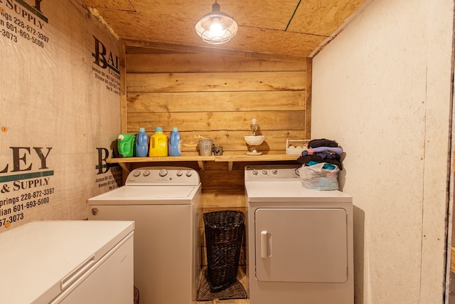 clothes washing area with washing machine and dryer