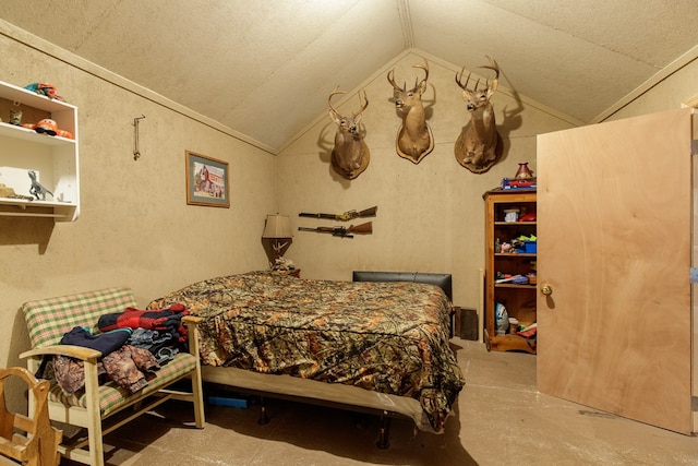 bedroom with a textured ceiling and vaulted ceiling