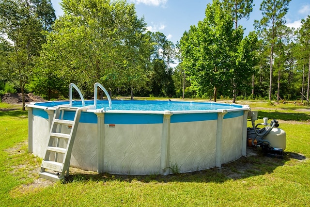 view of swimming pool with a lawn