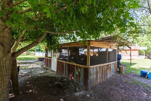 view of side of home with a sunroom