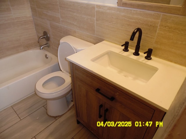 6 Prince Cv, Valdosta, GA 31601 - bathroom featuring bathtub / shower combination, decorative backsplash, vanity, and toilet