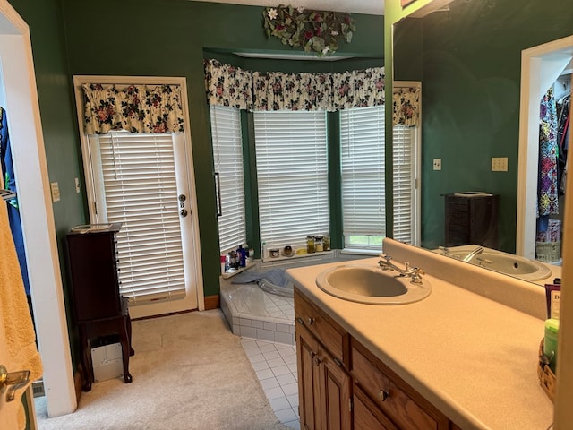 bathroom with a tub to relax in, tile patterned flooring, and vanity