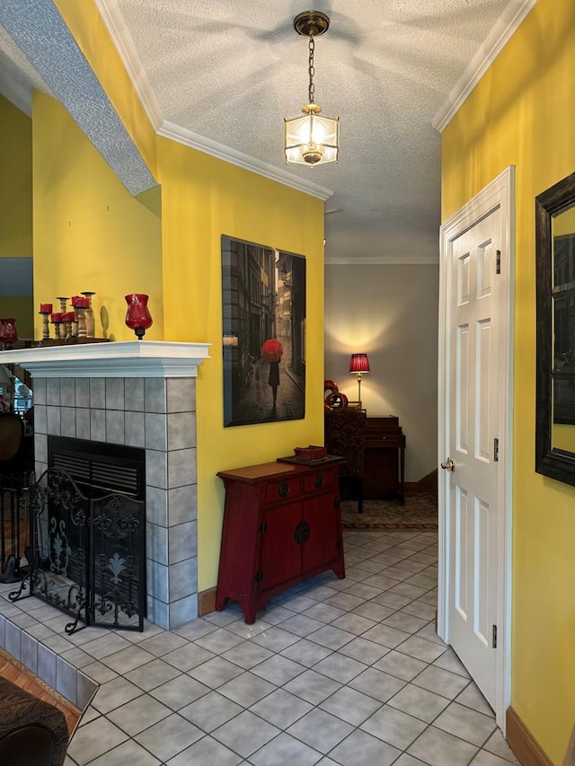 living room featuring a textured ceiling, a fireplace, light tile patterned flooring, and crown molding