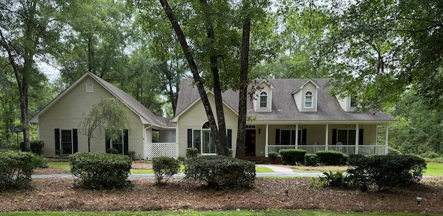 cape cod-style house featuring a porch