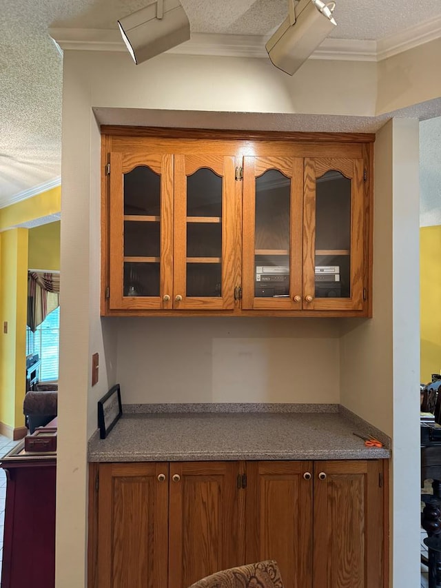 kitchen featuring ornamental molding and a textured ceiling