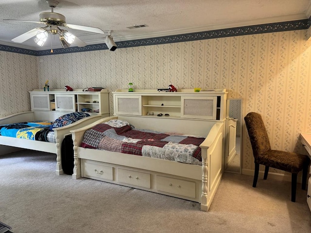 carpeted bedroom featuring ceiling fan, a textured ceiling, and ornamental molding