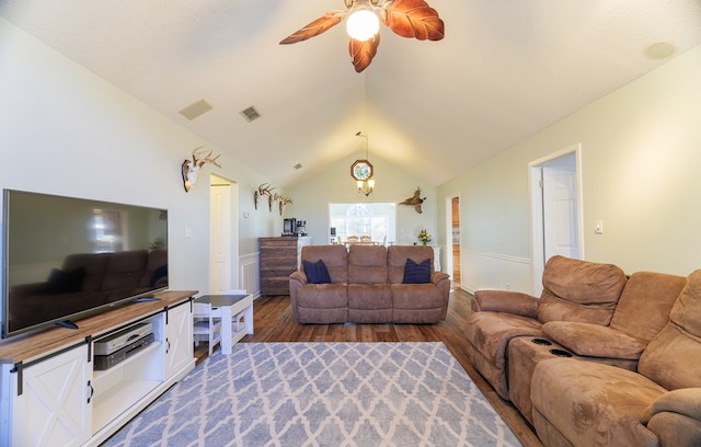 living room with vaulted ceiling, ceiling fan, and wood-type flooring