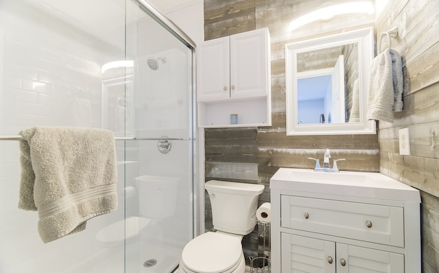 bathroom with toilet, walk in shower, and vanity