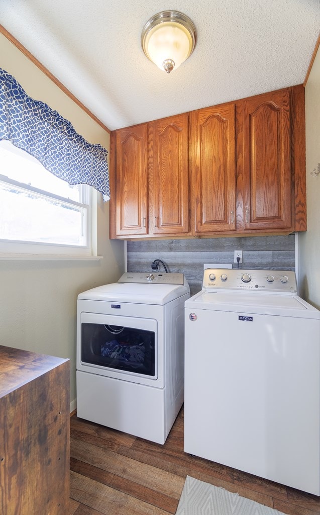 laundry area with washer and dryer, cabinets, a textured ceiling, and dark hardwood / wood-style floors